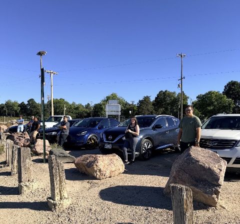 Cars parked behind the rocks and posts at the overlook